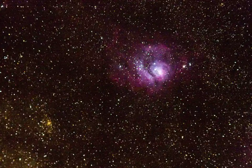 A photograph of a star-filled night sky with a prominent purple and pink nebula at its center. Overlaid text reads 'i'm not…