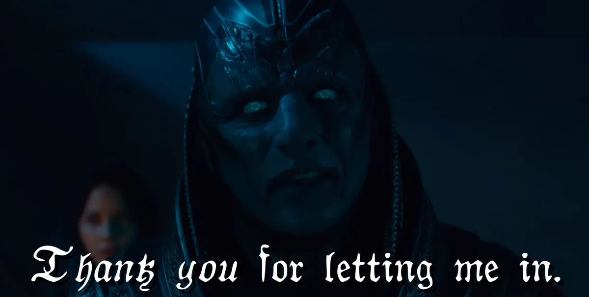 A close-up of a menacing, blue-skinned alien with glowing eyes and ornate headgear, set against a dark background with a…