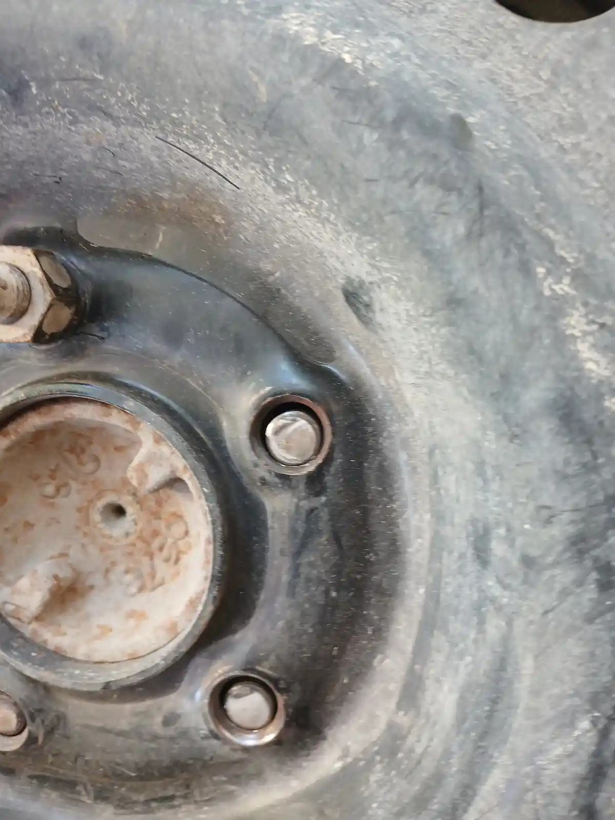 A close-up photo of a rusty, worn car part with bolts and a circular component, overlaid with the text 'i just fixed my car…