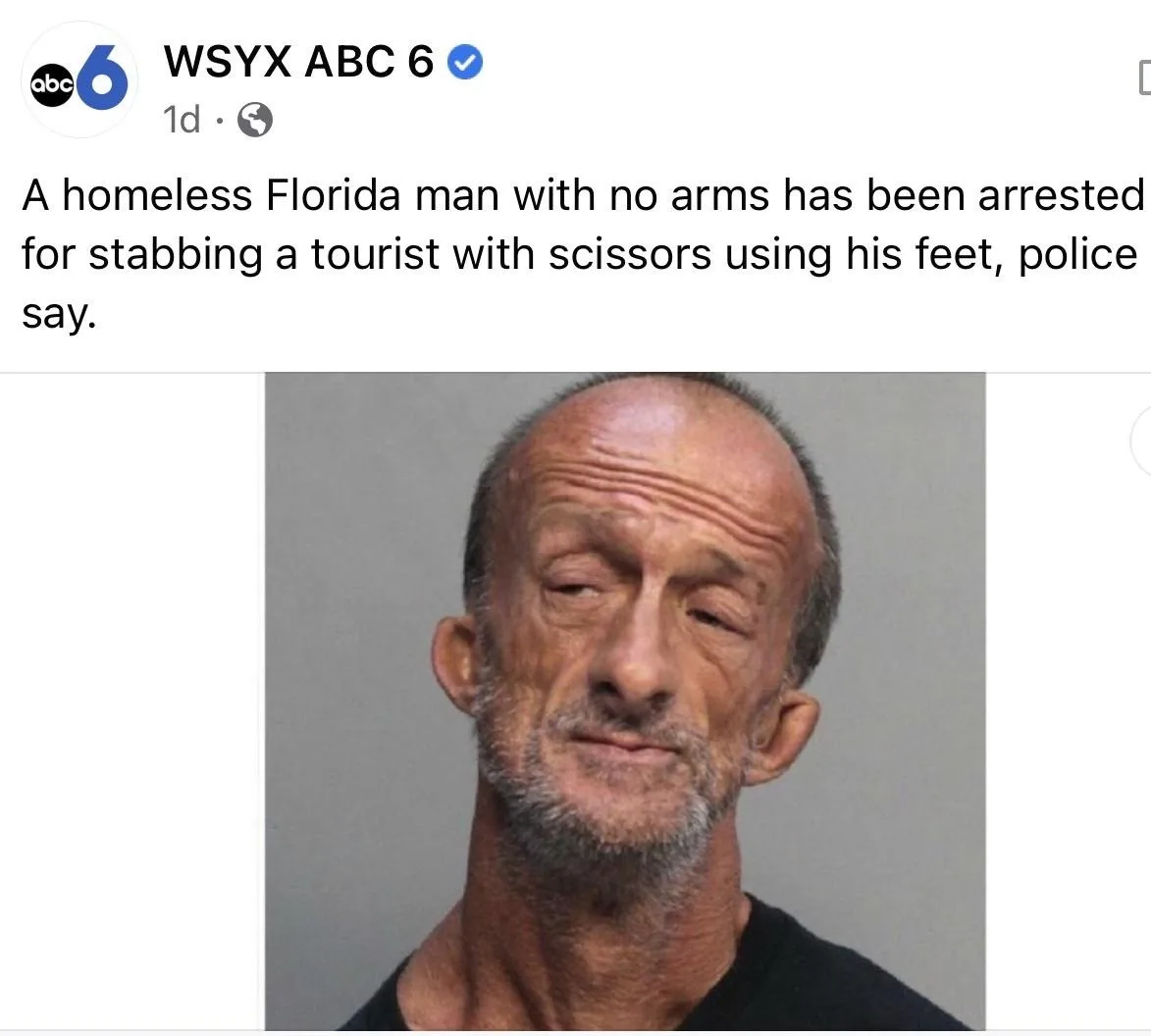 A mugshot of a man with a distinctive, wrinkled face and sparse grey hair, wearing a black shirt against a plain grey…