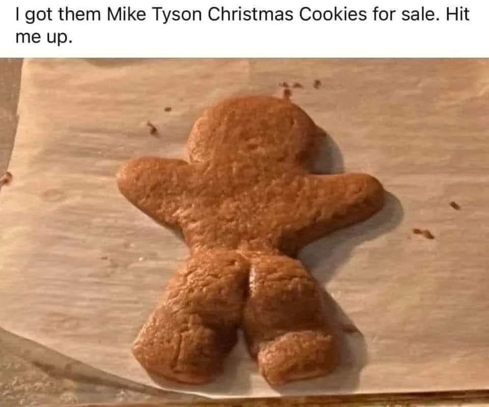 A plain gingerbread cookie shaped like a human figure with a notably wide, muscular lower body and thick legs, resembling…