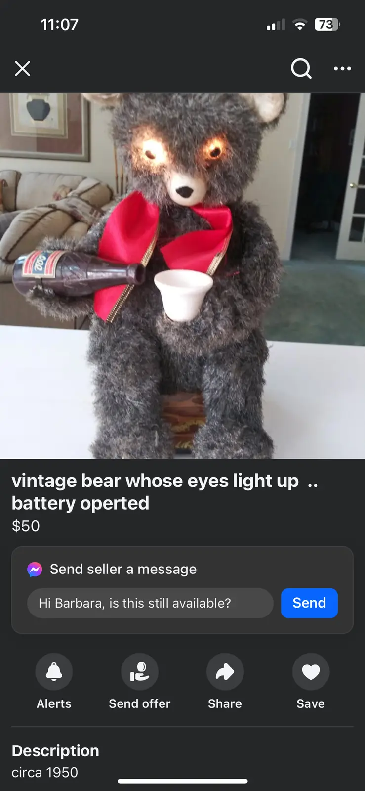 A vintage, battery-operated teddy bear with glowing eyes, wearing a red scarf and holding a bottle and cup, is listed for…
