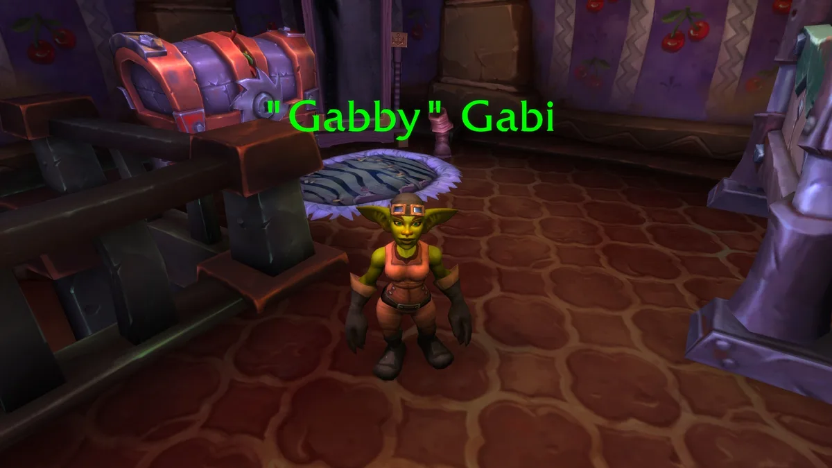 A green-skinned goblin character from World of Warcraft stands in a room with cherry-patterned wallpaper and a large chest…