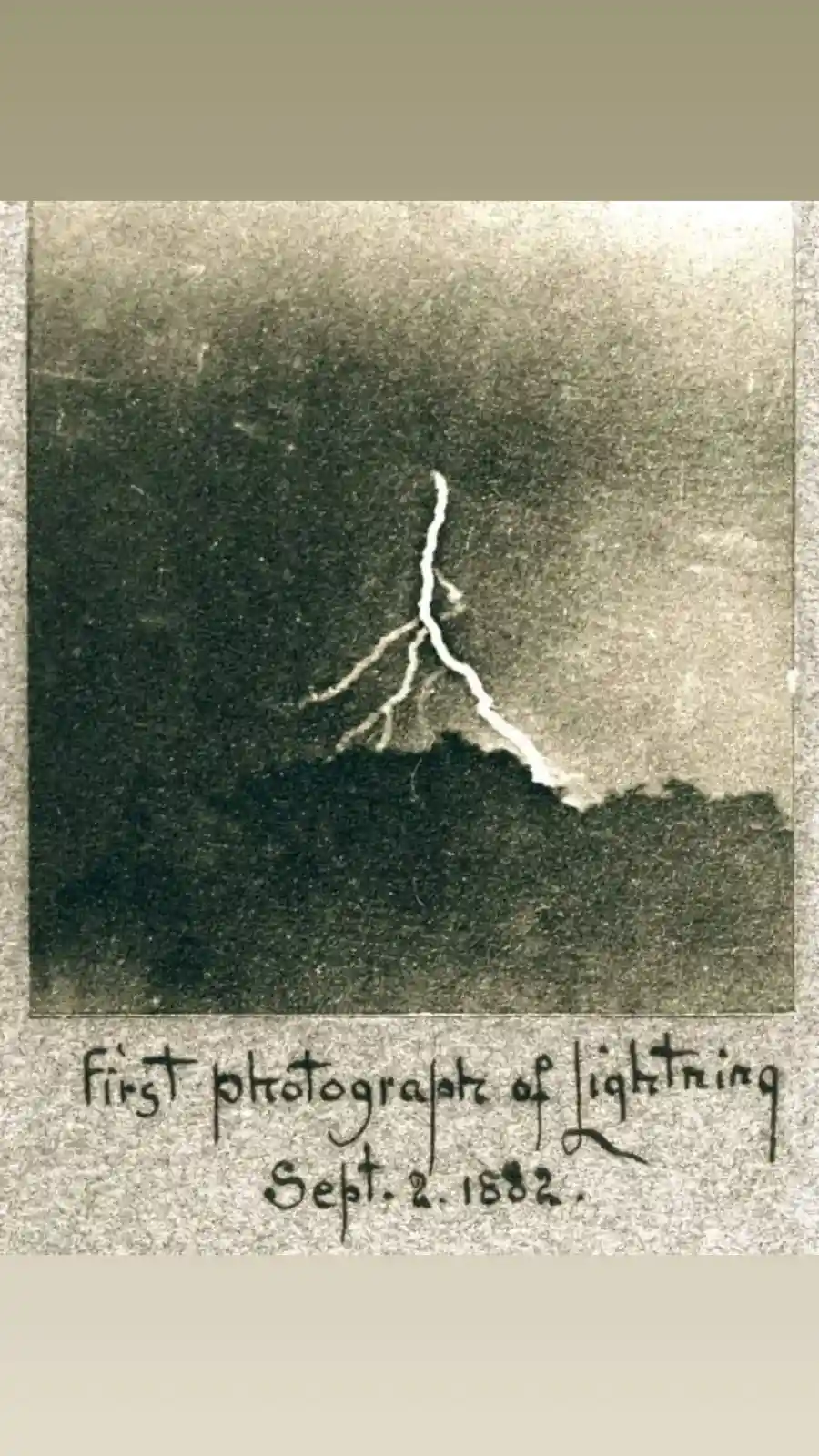 An old, grainy photograph shows a single bolt of lightning striking down from a dark sky above a silhouetted treeline. Below…