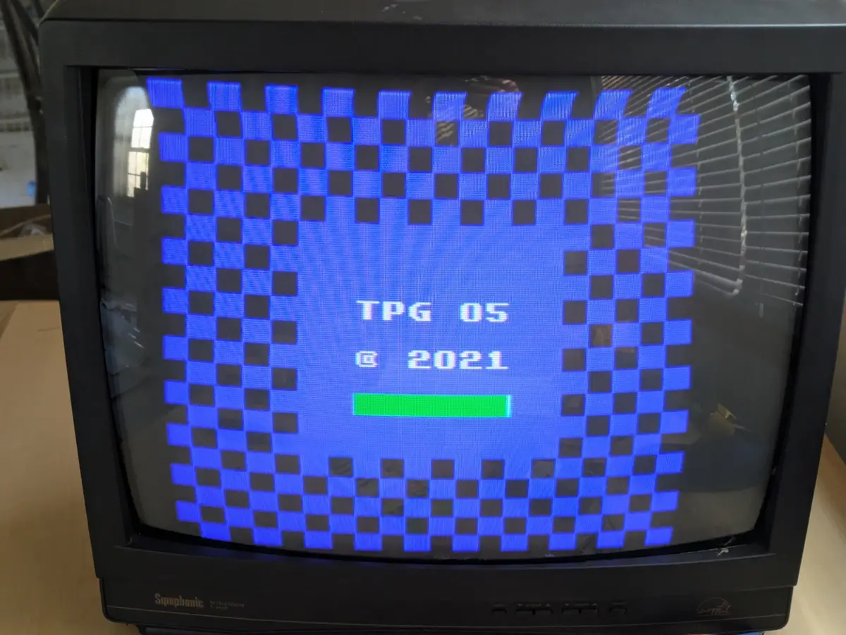 An old black CRT television displays a blue and black pixelated checkered pattern resembling a retro video game loading…