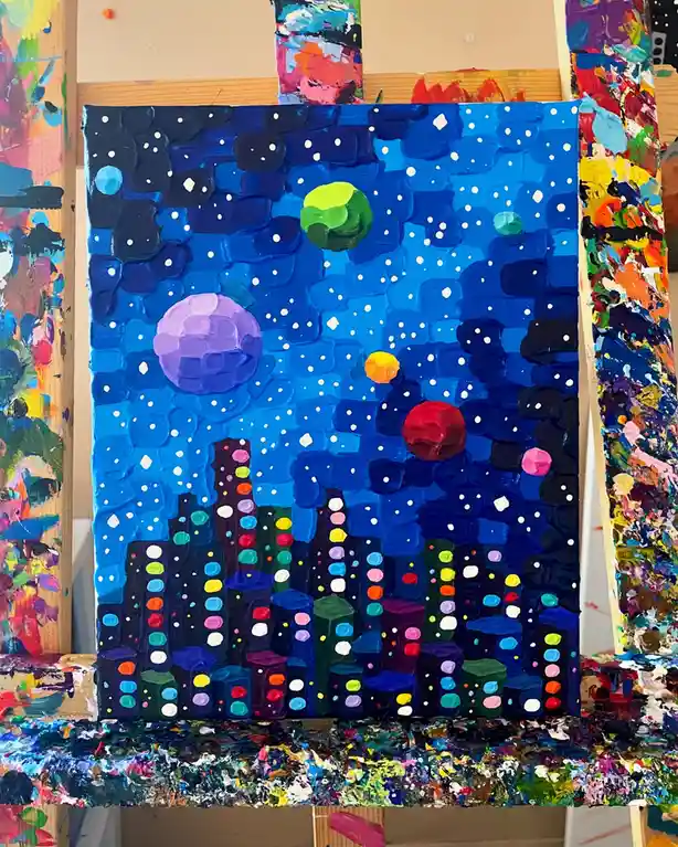 A thickly textured, colorful painting depicts a city skyline at night with buildings adorned in multicolored lights, set…