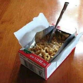 A nearly empty cereal box with a spoon stuck in the remaining cereal, a crumpled napkin on top, and the text 'i'm not lazy…