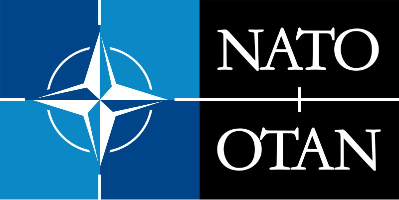 The image displays the NATO logo on the left side, split vertically by a white line, with the acronym 'NATO' in white text…