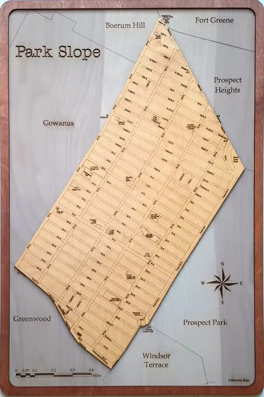 A wooden, laser-etched map of Park Slope, Brooklyn, showing streets and landmarks like Prospect Park, Prospect Heights, and…