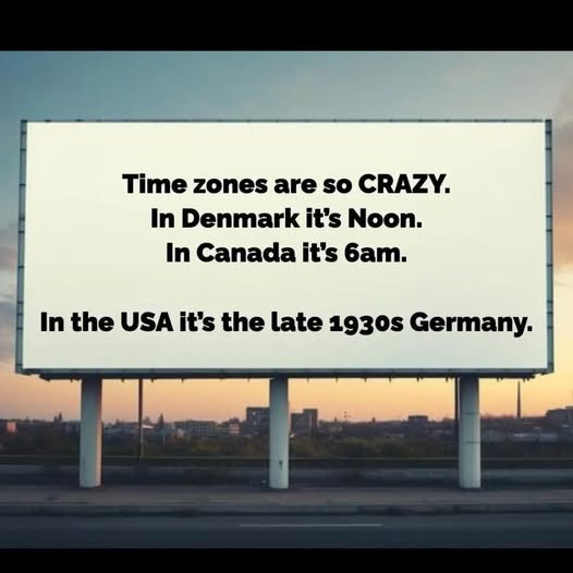 A large white billboard stands on a highway at dusk, displaying black text that reads: 'Time zones are so CRAZY. In Denmark…