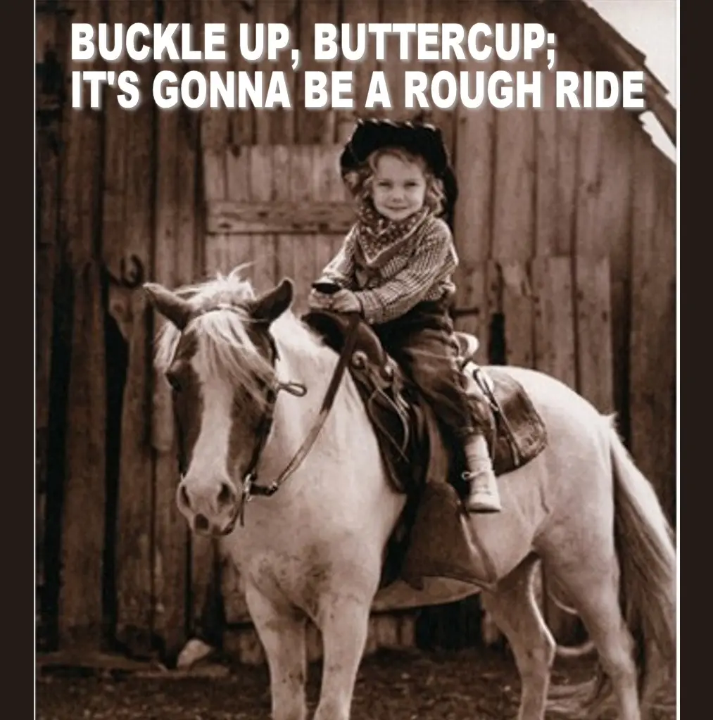 A sepia-toned vintage photo shows a young child with curly hair, wearing a cowboy hat, bandana, and western attire, sitting…