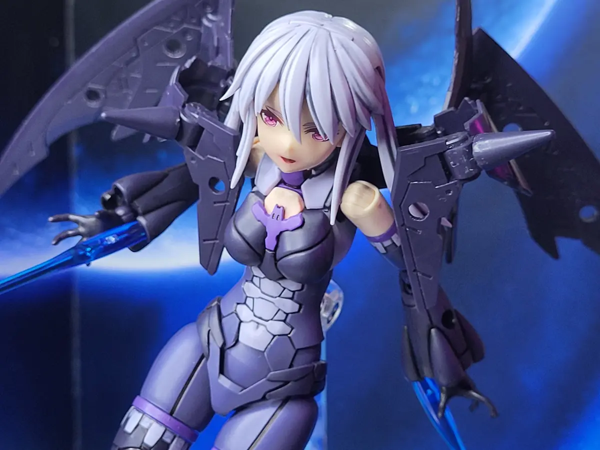 A close-up of a female anime-style figurine with silver hair and pink eyes, wearing a purple and gray armored outfit with…