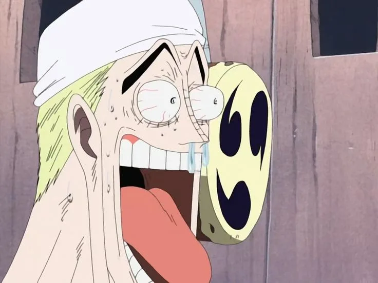 An anime character with a white headband and green hair is shown with an exaggerated expression of shock or distress, eyes…
