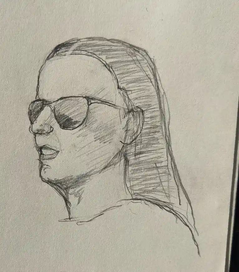 A pencil sketch depicts a person in profile wearing sunglasses, with long hair pulled back, and their mouth slightly open…