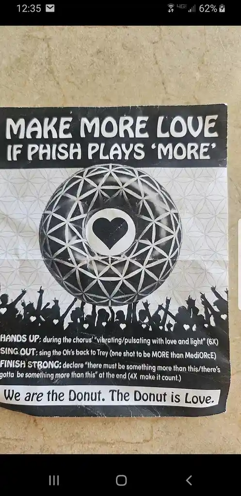 A black-and-white poster for a Phish concert chant, featuring a geometric sphere with a heart at its center above…
