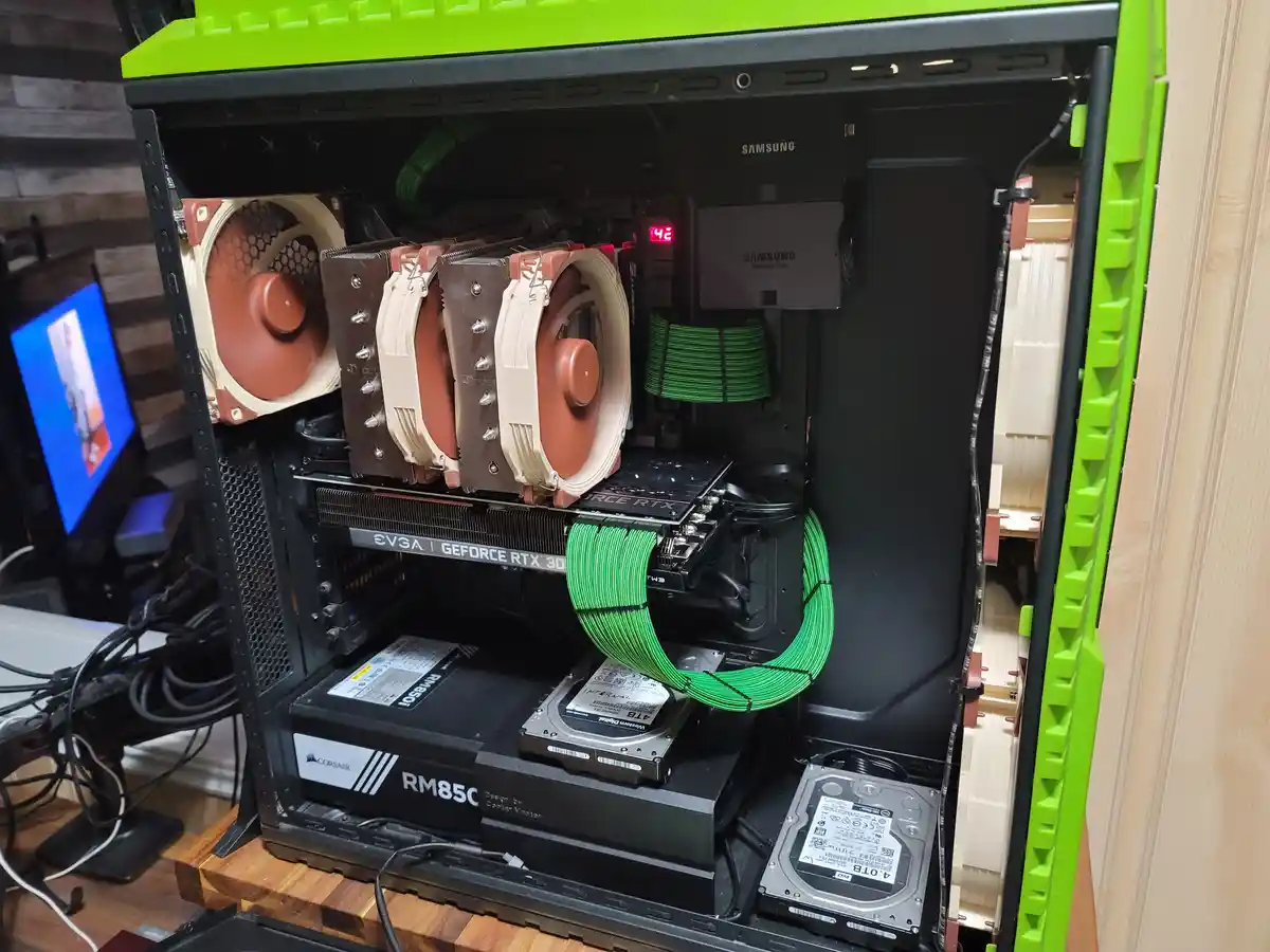A custom-built PC with a bright green case is shown with its side panel removed, revealing internal components including a…