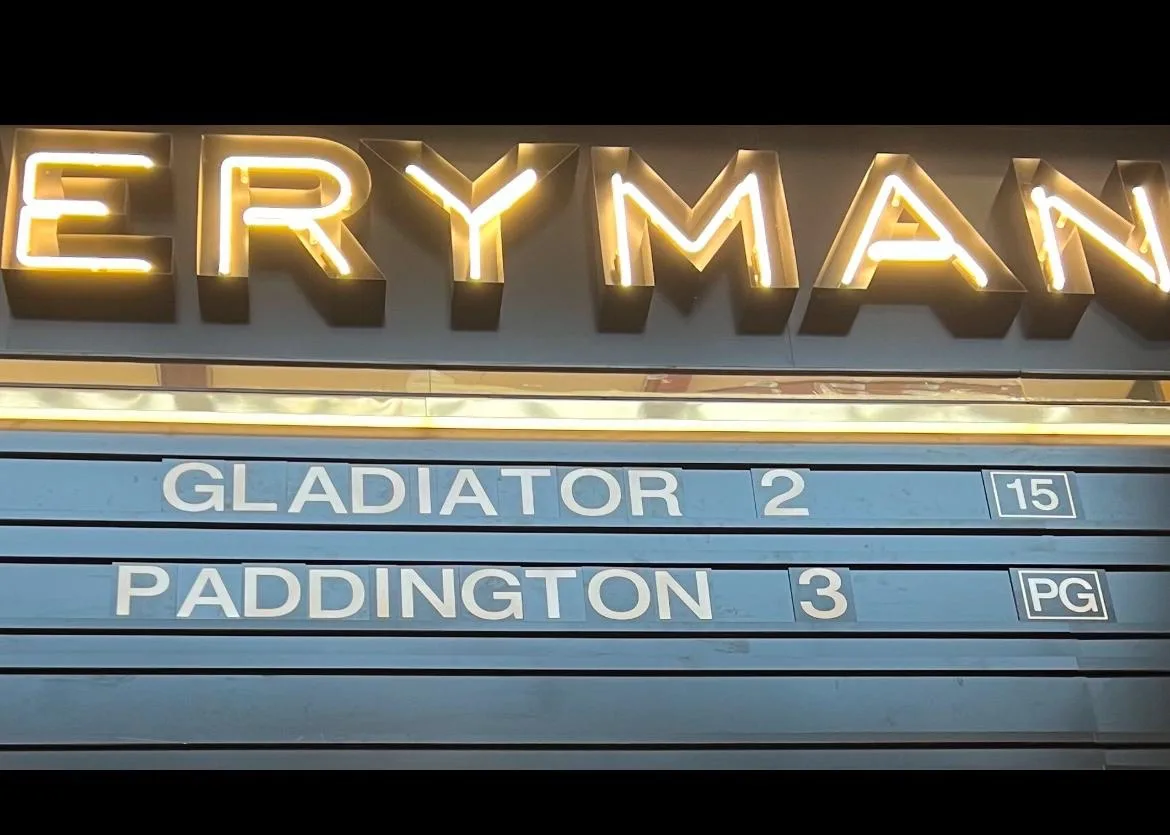 A close-up of a cinema marquee showing 'GLADIATOR 2' rated 15 and 'PADDINGTON' rated PG, with the cinema name 'ERYMAN'…