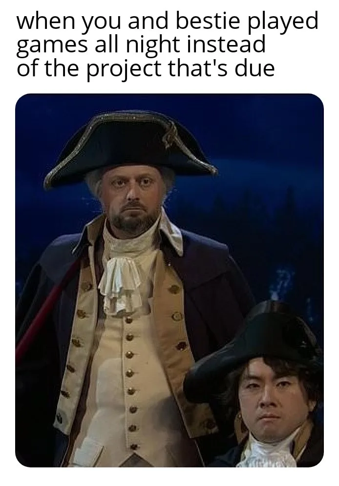 The image shows two men dressed in colonial-era military uniforms with tricorn hats. The man in the foreground has a weary…