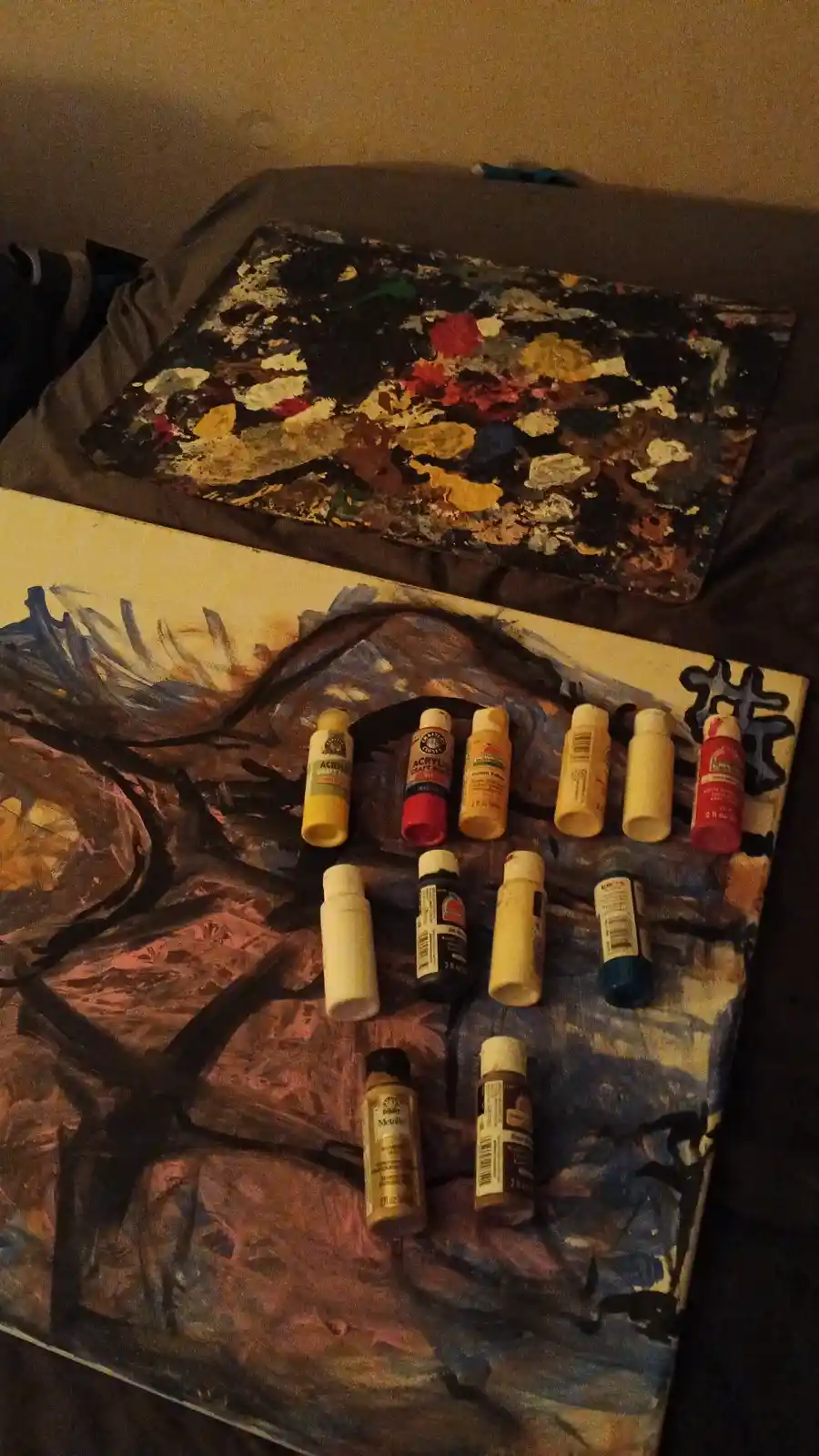 A close-up photo shows a partially painted canvas with a row of small acrylic paint bottles arranged neatly on top of it…