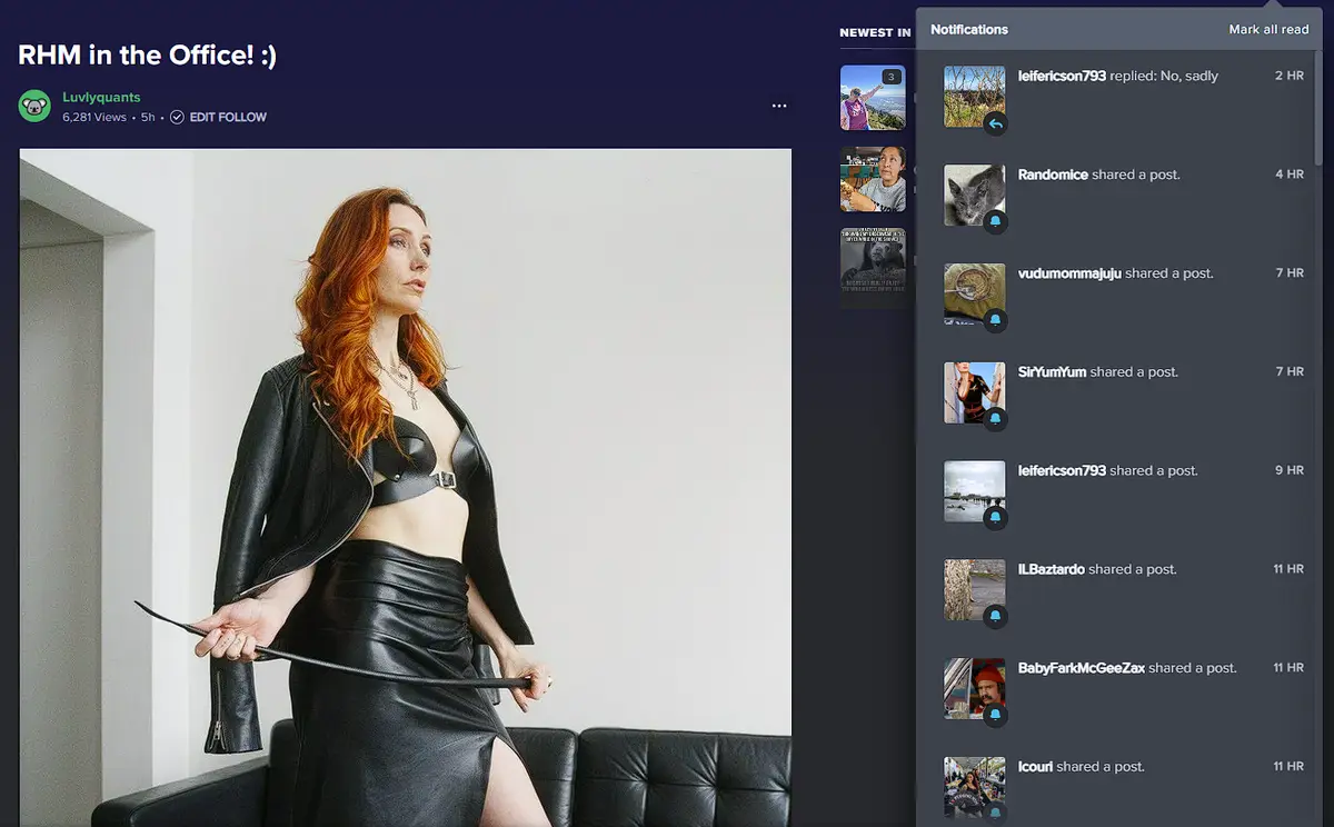 A woman with red hair wearing a black leather outfit and holding a whip sits on a black couch, overlaid with a social media…