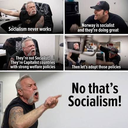 A four-panel meme featuring a man with tattoos and a beard reacting to a discussion about socialism. In the first panel, he…