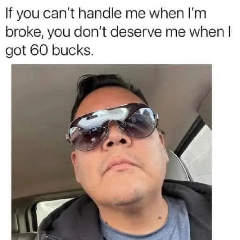 A man wearing large, reflective sunglasses sits in a car, looking confidently upward with a smug expression. The overlaid…