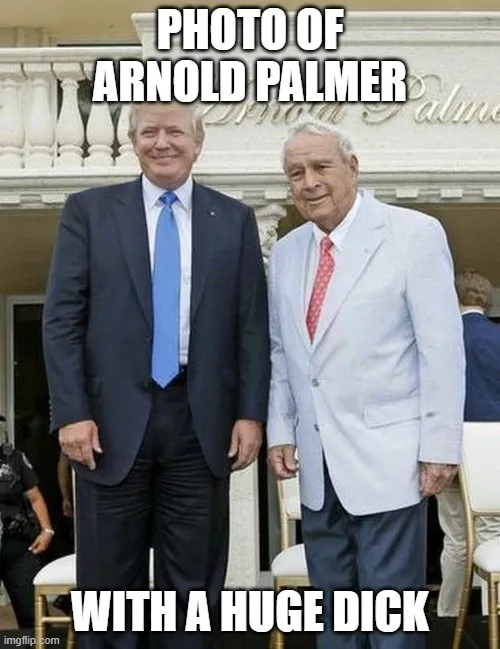 Two men in suits stand side-by-side smiling in front of a building with 'Arnold Palmer' written on it. The man on the left…