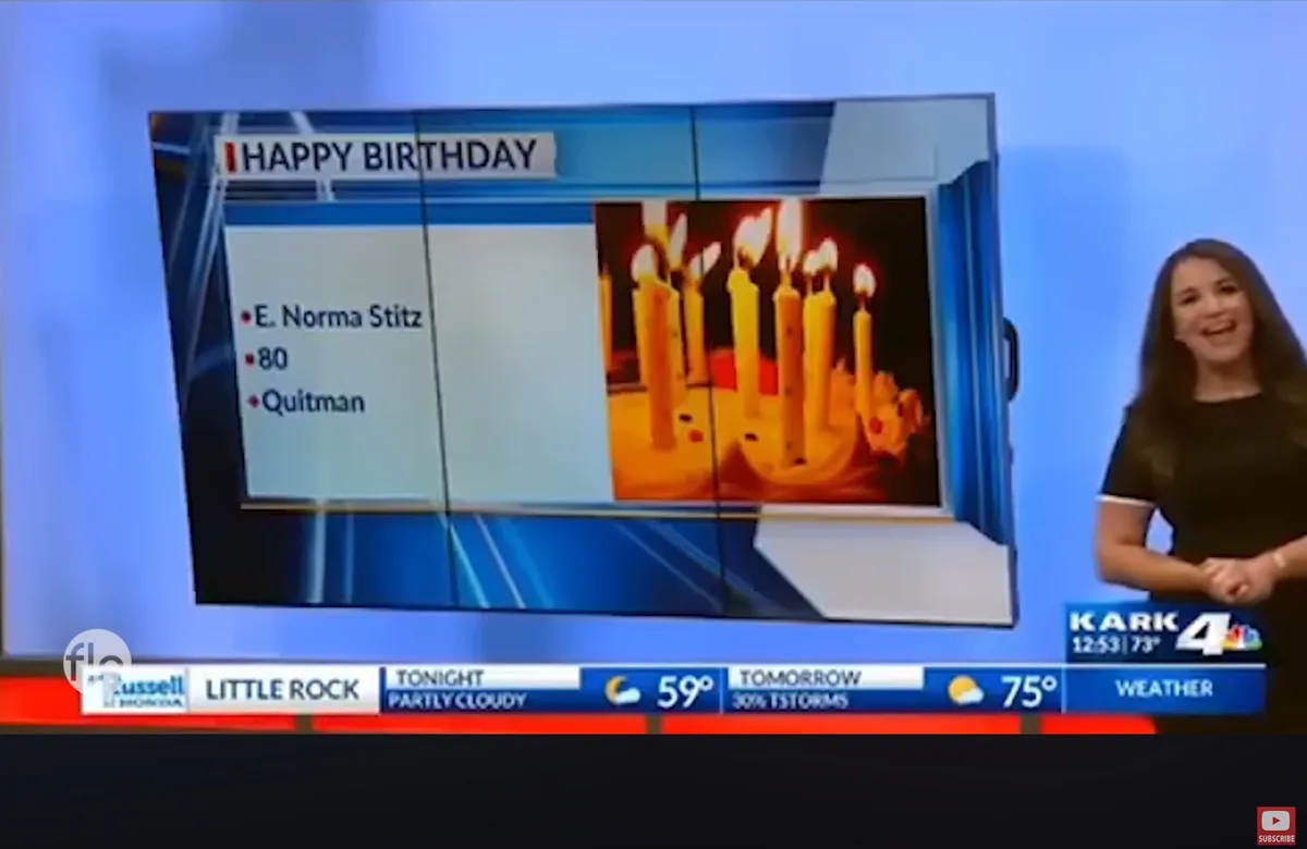 A news anchor smiles beside a screen showing a 'HAPPY BIRTHDAY' graphic for E. Norma Stitz, age 80, from Quitman, with an…