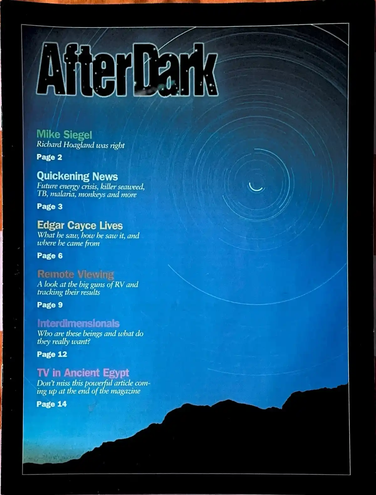 The image shows the cover of a magazine titled 'AfterDark' with a blue background featuring concentric circles and a…