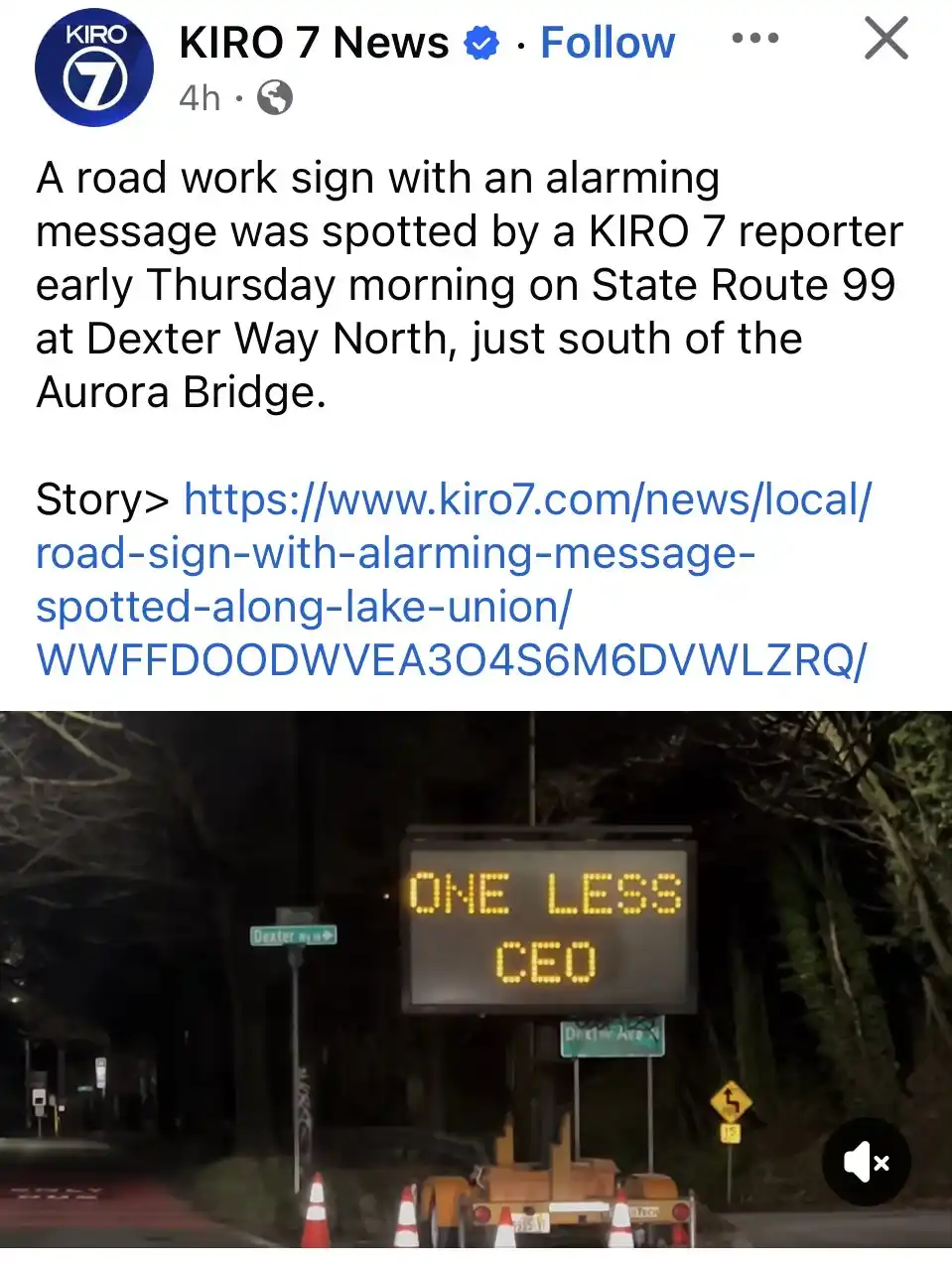 A nighttime photo shows a digital road sign displaying the text 'ONE LESS CEO' in yellow LED letters. The sign is mounted on…