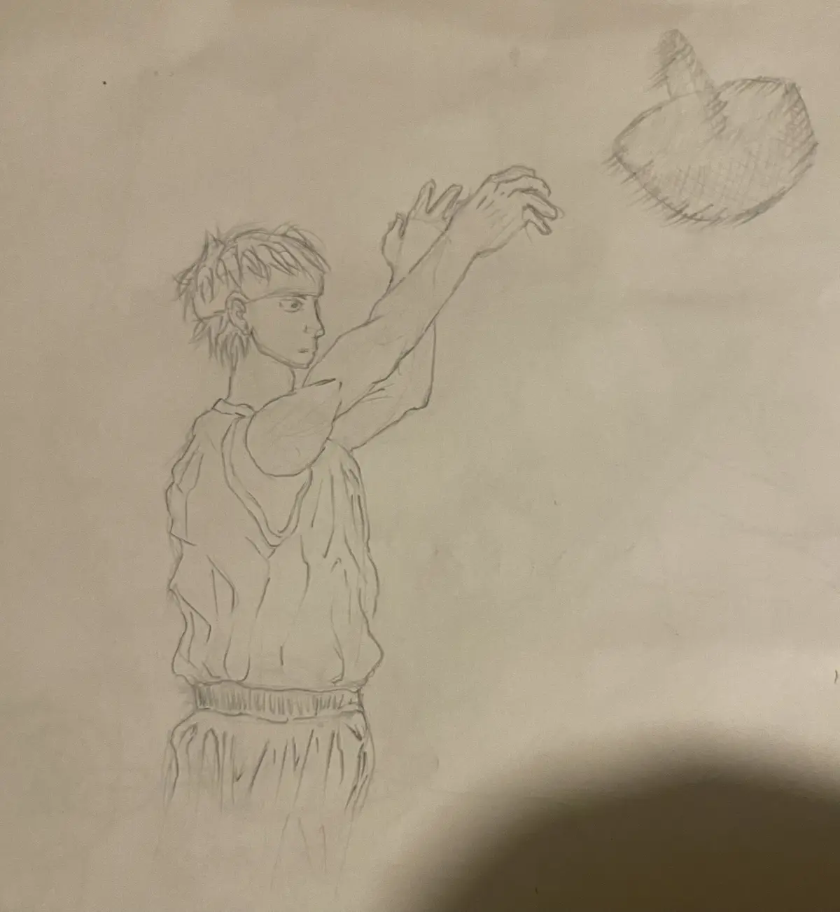 A pencil sketch shows a young man in athletic attire, arms raised as if shooting a basketball, with a basketball drawn above…
