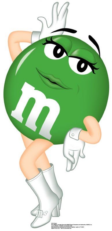 A green M&M character with a sultry expression, wearing white gloves and high-heeled boots, strikes a confident pose with…