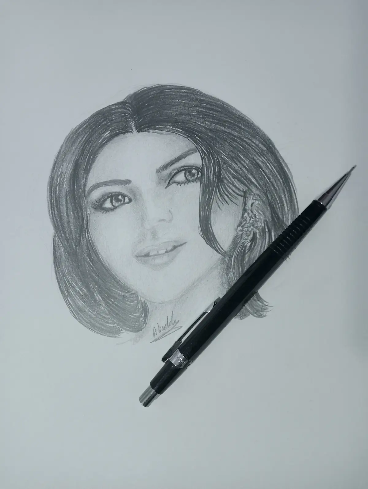 A detailed pencil sketch of a woman's face with short, styled hair and a visible earring, signed 'Abuelo' near the chin. A…