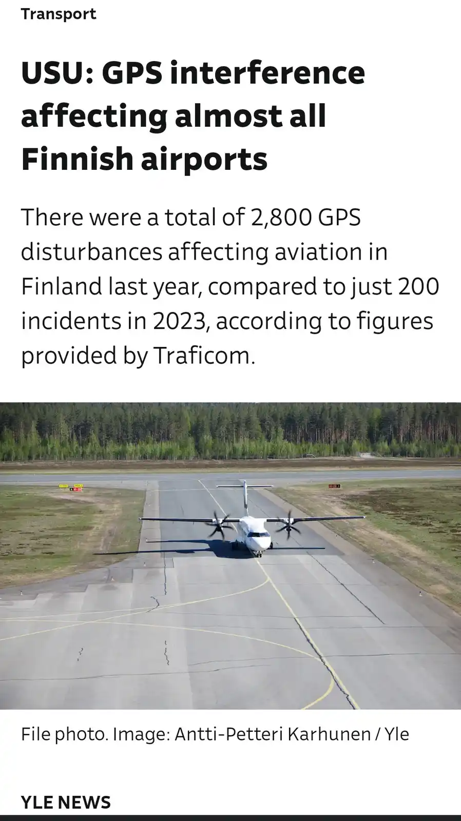 A news article screenshot shows a white twin-propeller airplane on an airport runway with a forest in the background. The…