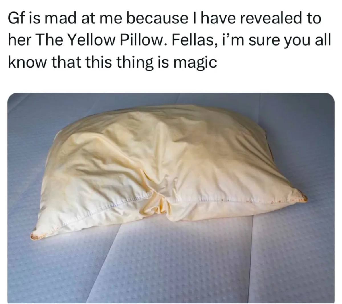 A pale yellow pillow with visible stains and frayed edges rests on a light blue, textured mattress. The overlaid text reads…