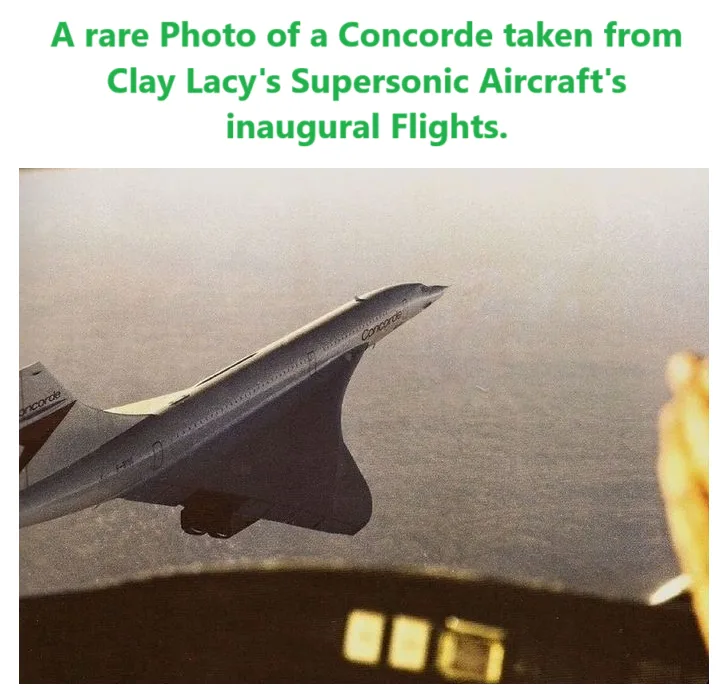 The image shows a silver Concorde supersonic jet flying above a hazy sky, viewed from inside another aircraft. The…