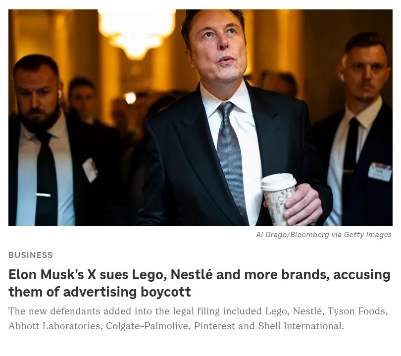 A man in a dark suit and tie, holding a coffee cup, looks upward with a serious expression. Two other men in suits stand…