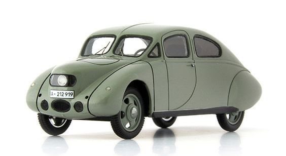 A green, vintage, rounded car model with a license plate reading 'a-212-919' is shown against a white background. The car…