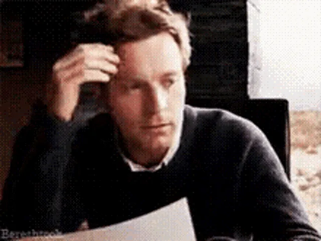 A six-panel GIF shows actor Ewan McGregor in a dark sweater reacting to something on paper. He starts with a hand on his…