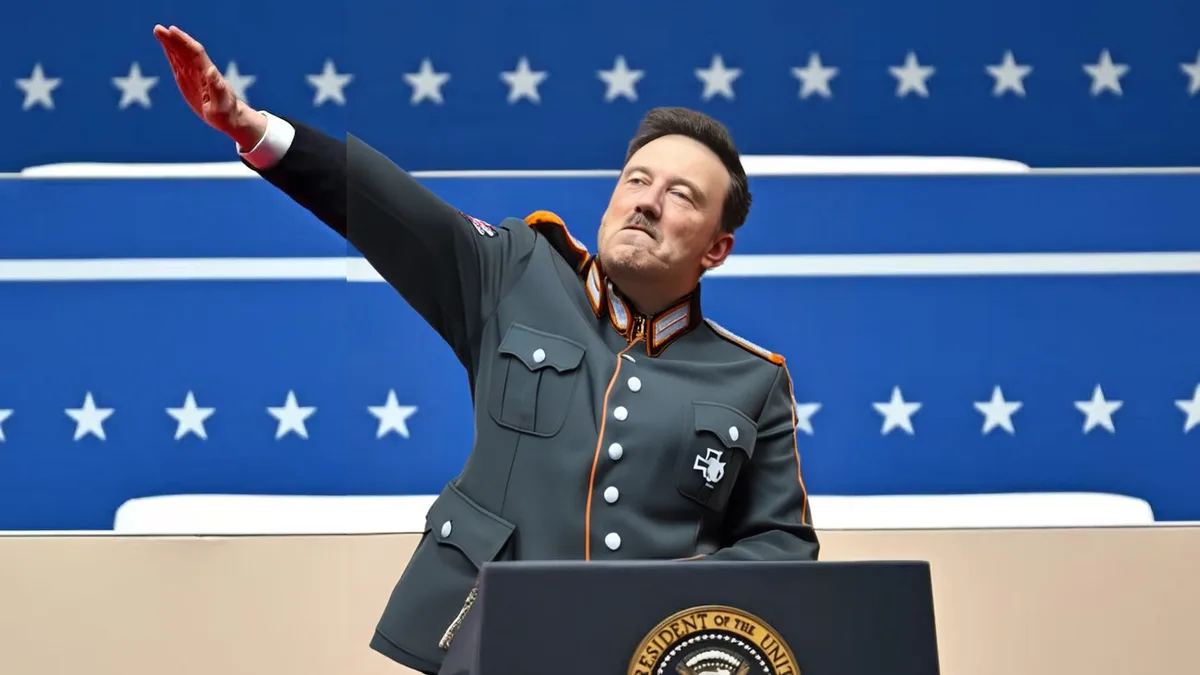 a man in a dark grey military-style uniform with orange trim and a swastika patch on his chest stands at a podium bearing…