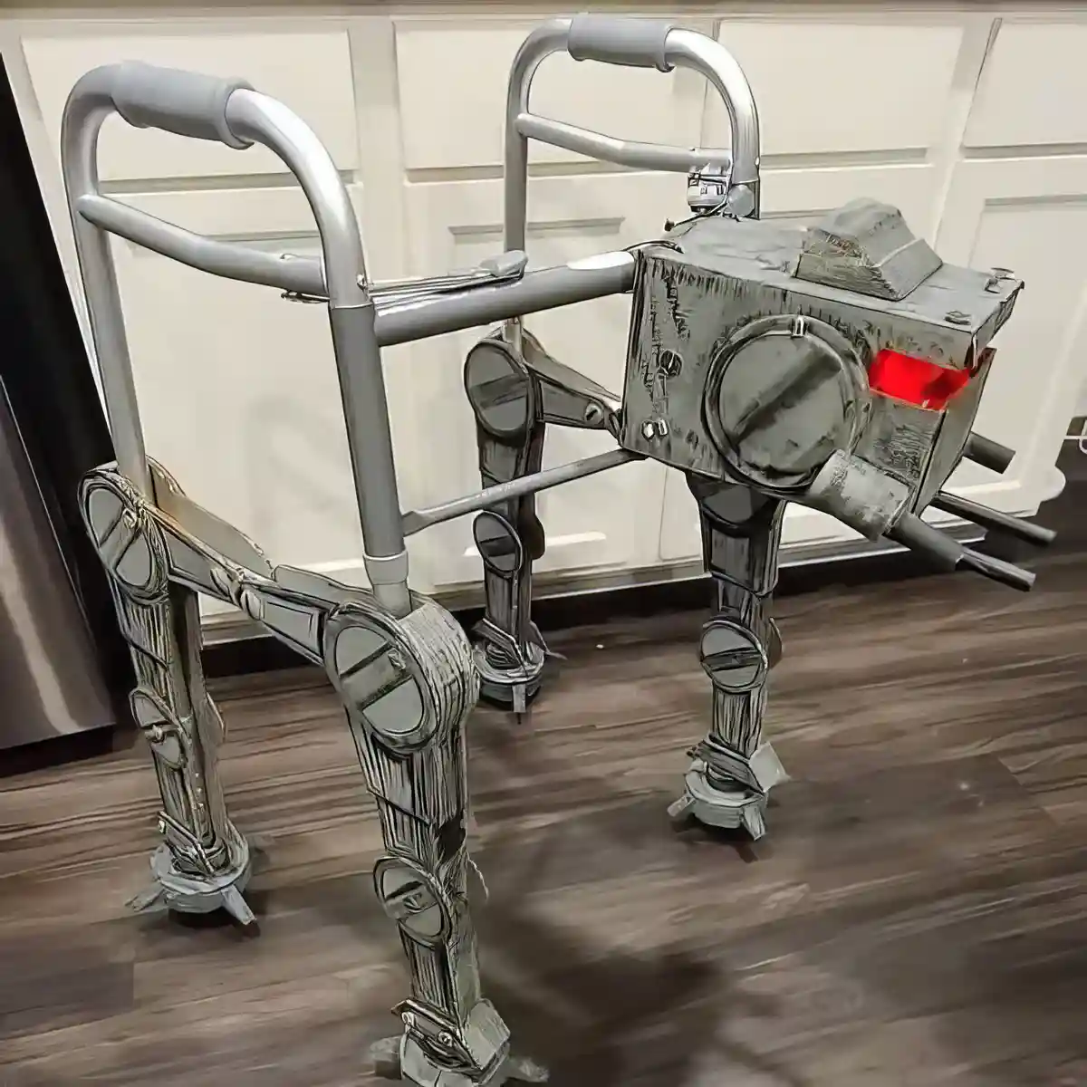A walker has been creatively modified to resemble a robot, with metallic limbs, a boxy head, and a glowing red light…