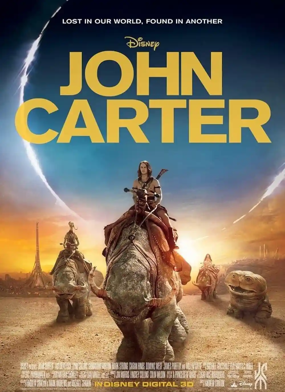 A movie poster for Disney's 'John Carter' shows a man riding a large, horned, armored creature across a desert landscape…
