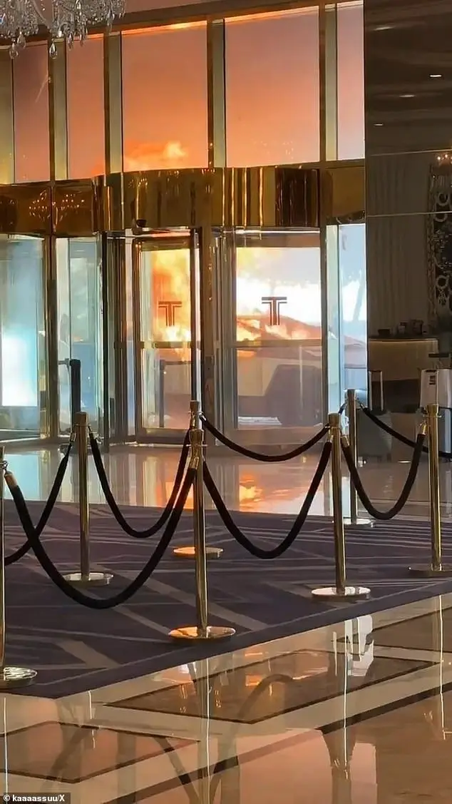 The image shows the opulent interior of a luxury building lobby with polished floors, velvet rope barriers, and golden…