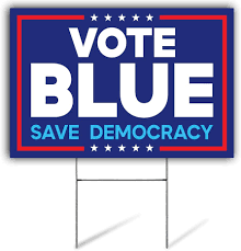 A political yard sign with a blue background, red border, and white stars. The text reads 'VOTE BLUE' in large white…
