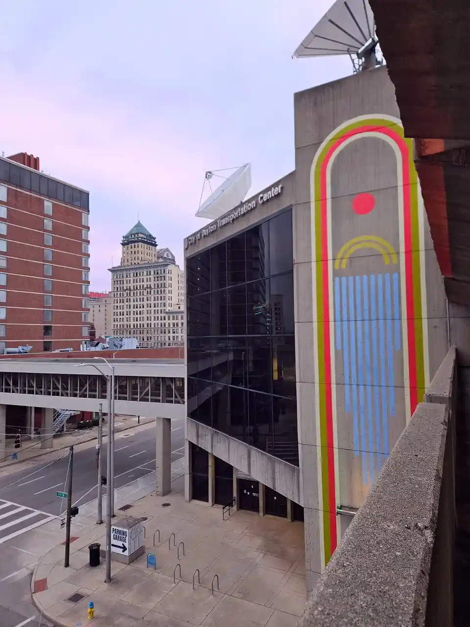An exterior shot of the City of Dayton Transportation Center, a modern concrete building with large glass windows and two…