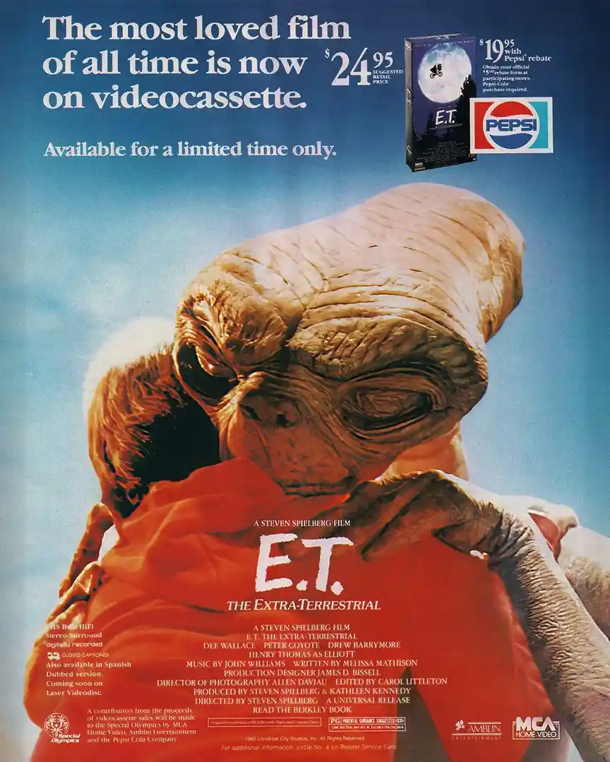 A vintage 1982 E.T. The Extra-Terrestrial VHS advertisement poster featuring the alien hugging a child against a blue sky…