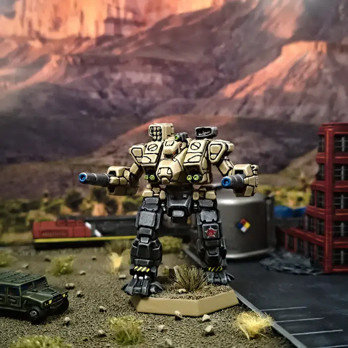 A large, tan and black painted robot miniature stands in a diorama with a desert canyon backdrop, a green military jeep, and…