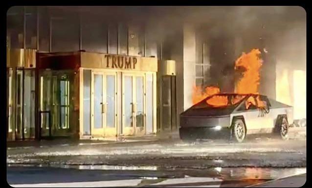 A Tesla Cybertruck is on fire in front of a building with a golden 'TRUMP' sign above its entrance. The vehicle is engulfed…