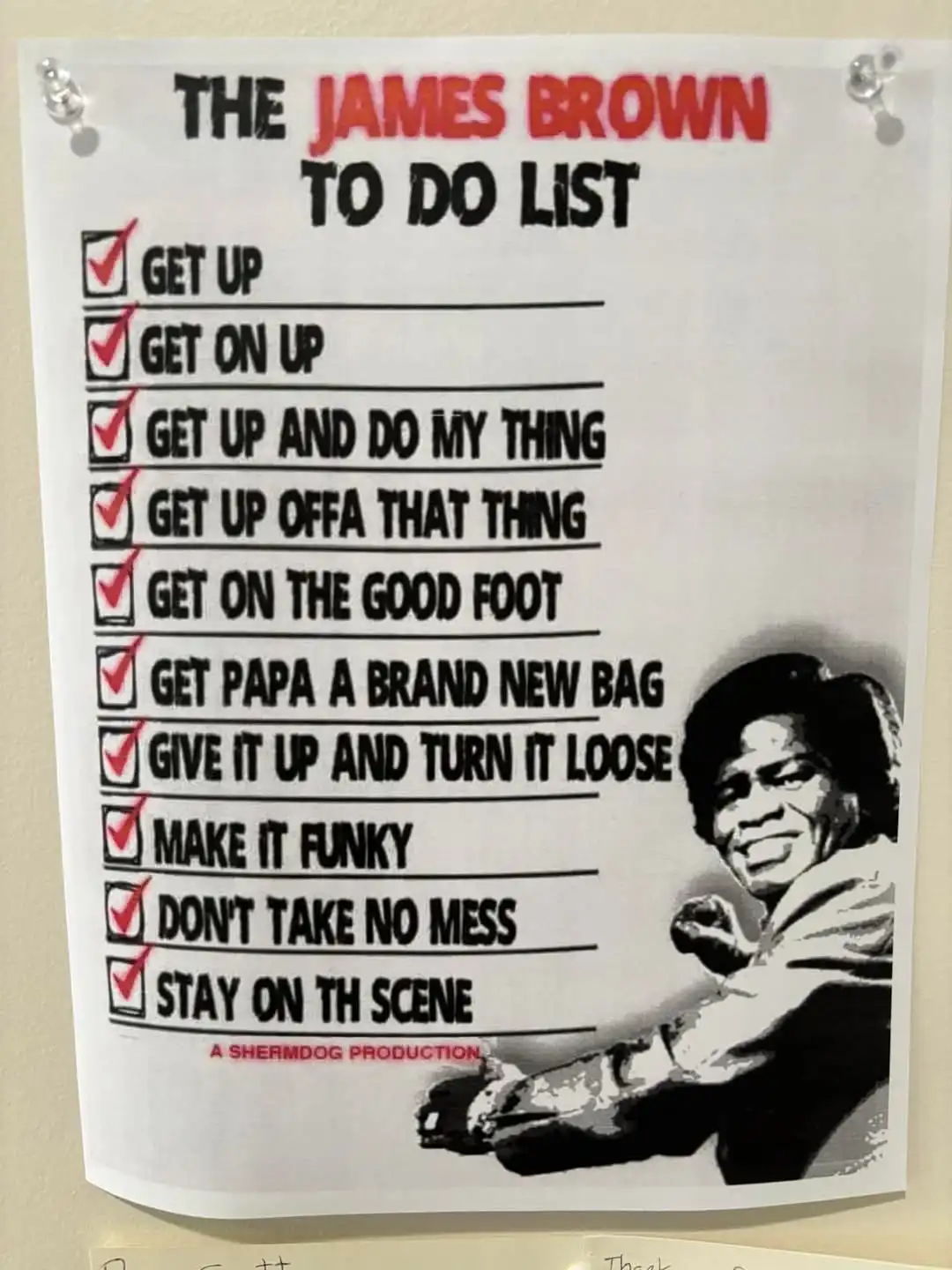 A printed checklist titled 'THE JAMES BROWN TO DO LIST' is pinned to a wall, featuring red checkmarks next to phrases like…