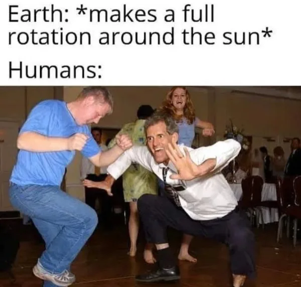 Two men are dancing energetically in a crowded room, one in a blue shirt and jeans, the other in a white shirt and dark…